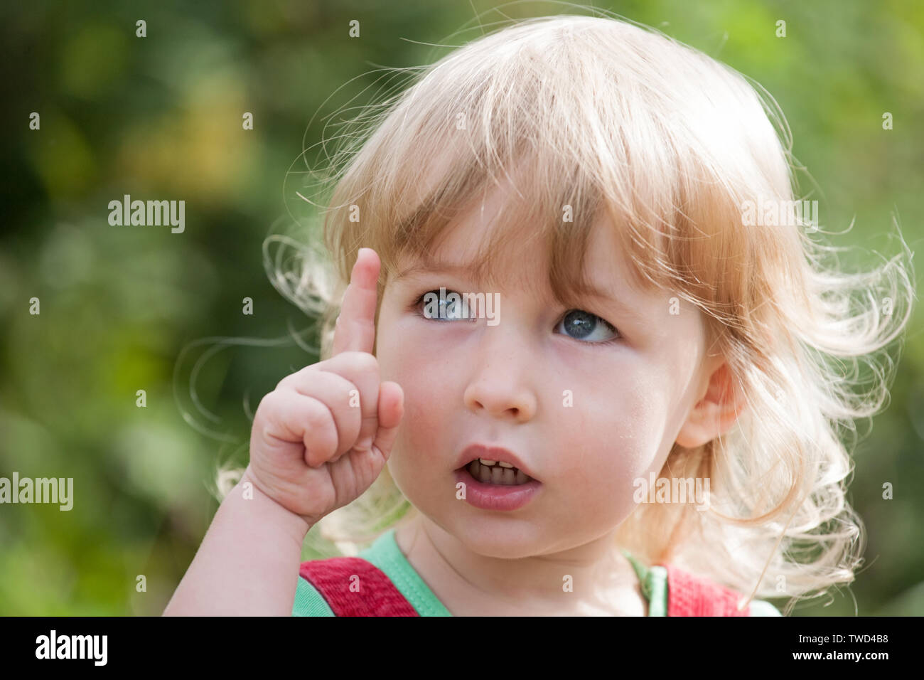 Cute kid girl avec l'index et face closeup Banque D'Images