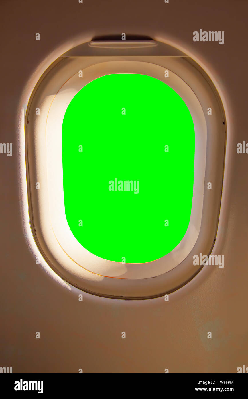 - Hublot fenêtre latérale de l'avion. Isolation vert Chroma key Banque D'Images