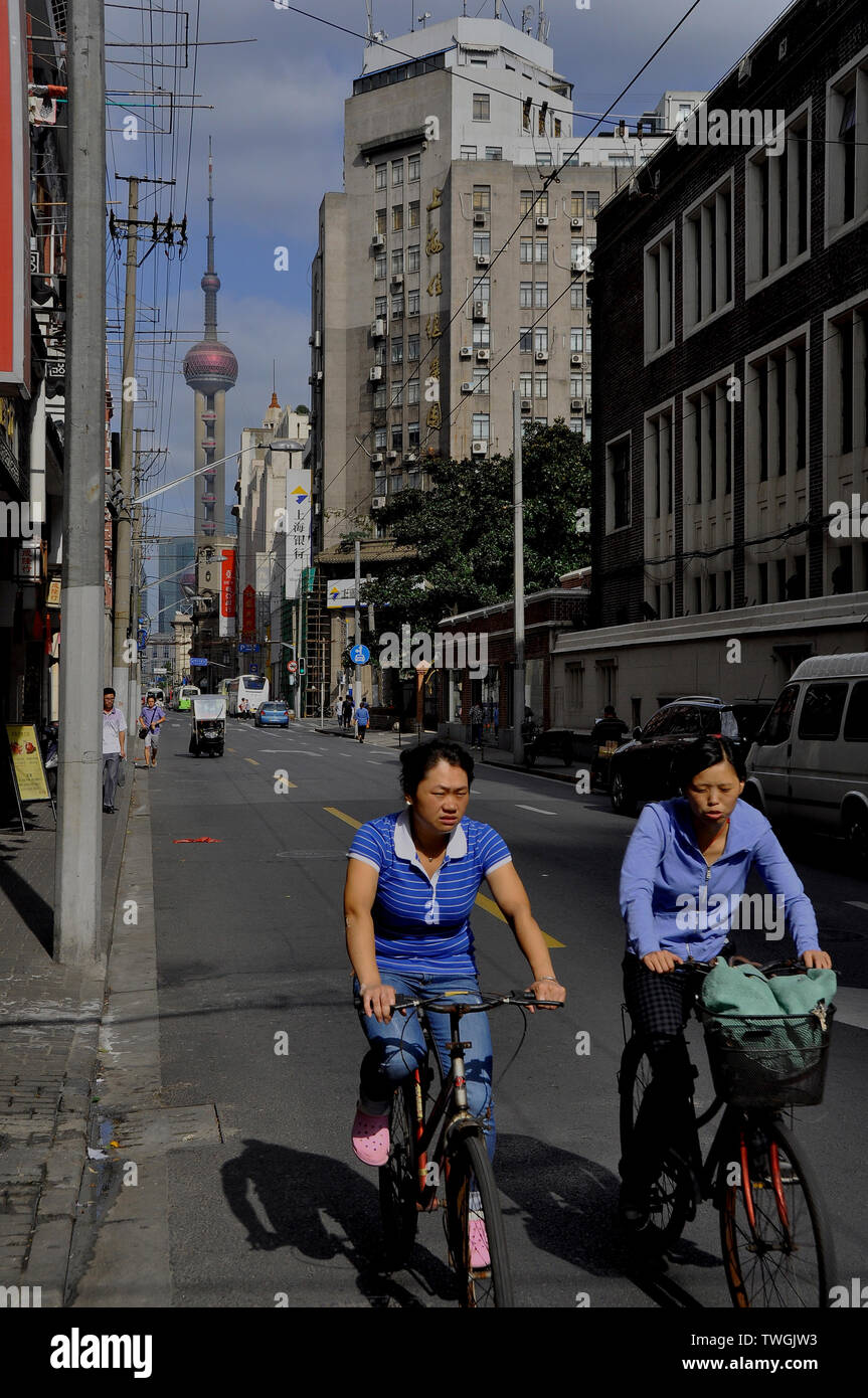 Deux amies sur un cycle Shanghai Street Banque D'Images