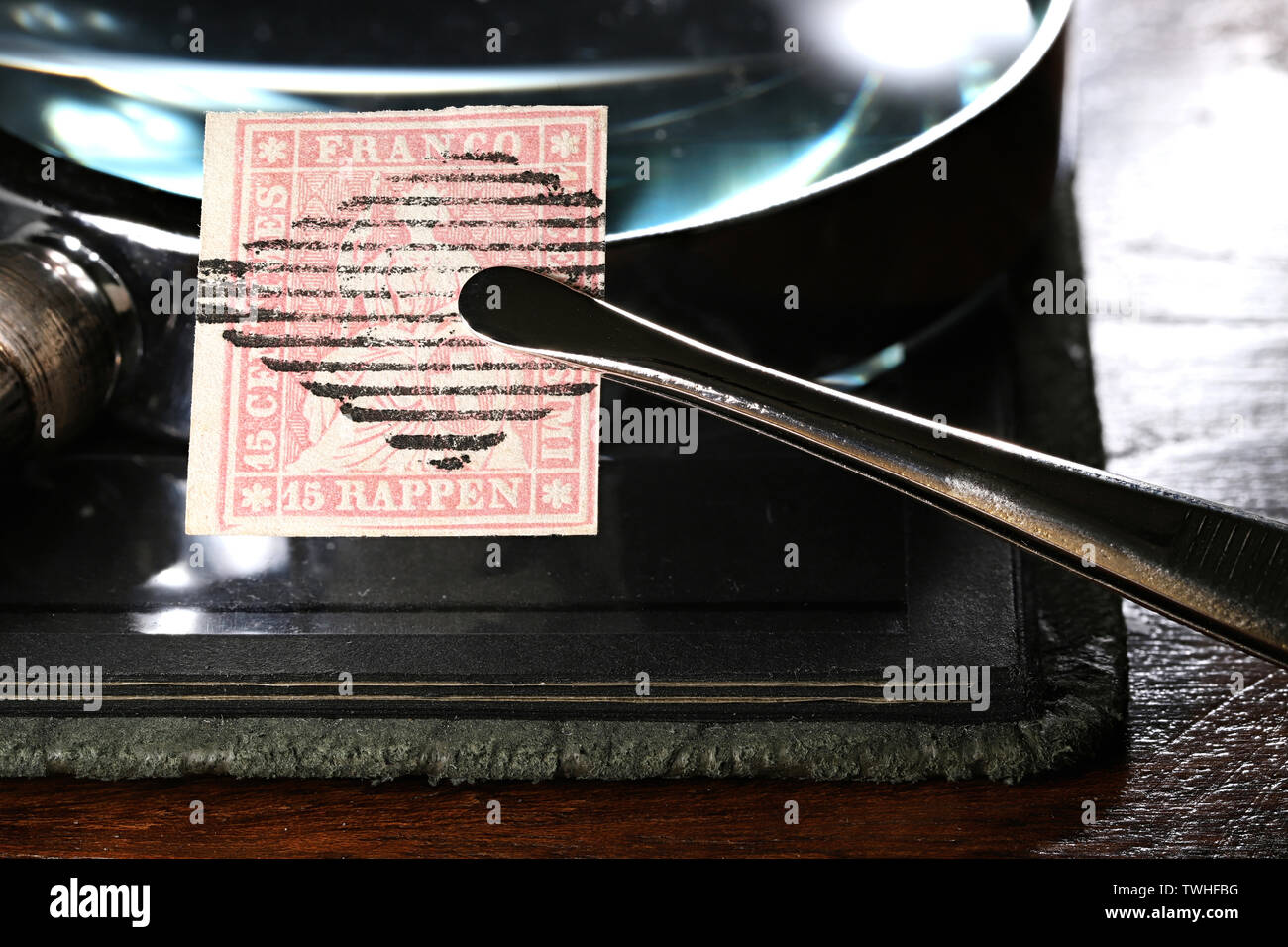 15 centimes suisses Strubel stamp détenues par des pincettes Banque D'Images