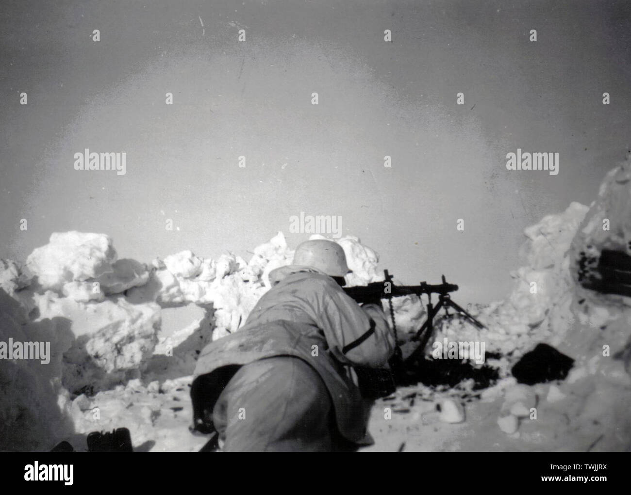 Soldat allemand en blanc Camouflage avec une MG34 dans une tranchée sur le front russe 1943 Banque D'Images