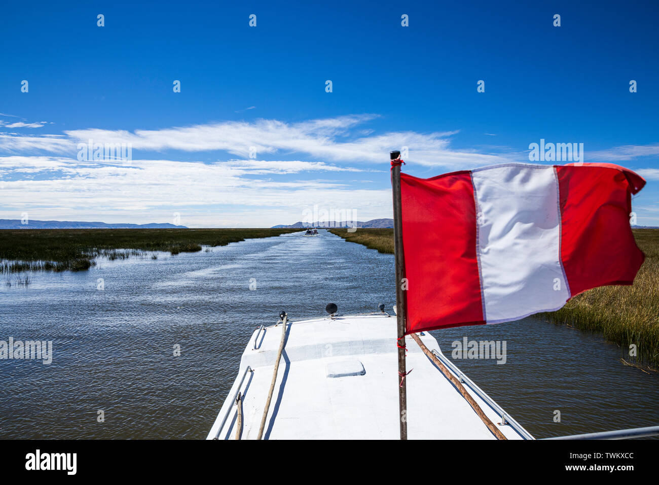 Le rouge et le blanc du drapeau national péruvien battant sur un bateau sur le lac Titicaca, le Pérou, Amérique du Sud Banque D'Images