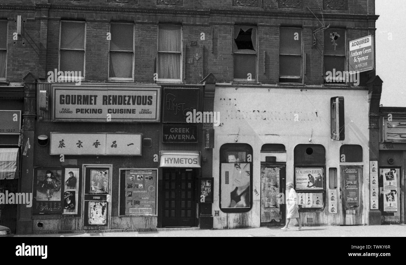 Une course vers le bas Street, Londres c1987 avec un restaurant chinois, Hymetos taverne grecque et voler des affiches pour des événements de musique y compris les Pixies, Gene Loves Jezabel et Tower Records. Photo par Tony Henshaw Banque D'Images