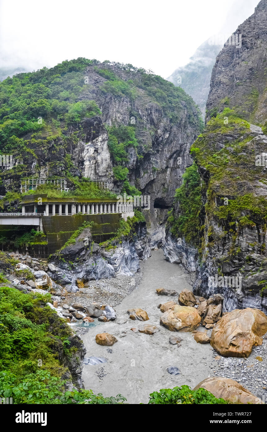 Vue imprenable sur les gorges de Taroko taïwanais un jour brumeux. Le parc national de Taroko est attraction touristique populaire à Taiwan. Des rochers entourant le lit du fleuve, vert tropical forest. La belle nature. Banque D'Images