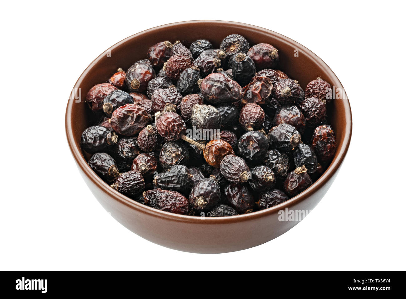 Cynorrhodons séchés dans un bol en bois. Fichier contient clipping path Banque D'Images