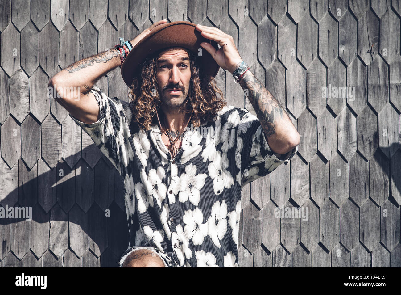 Portrait de tattooed man wearing hat et Hawaiian shirt Banque D'Images