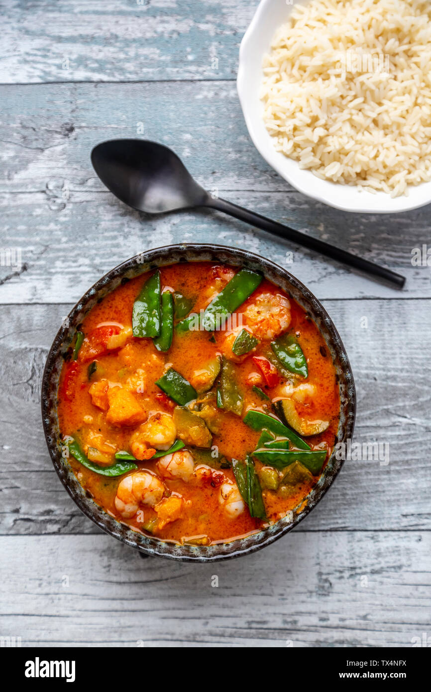 Curry Rouge à la patate douce, le jaune et le poivron rouge, courgette, pois de sucre, crevettes et riz Banque D'Images