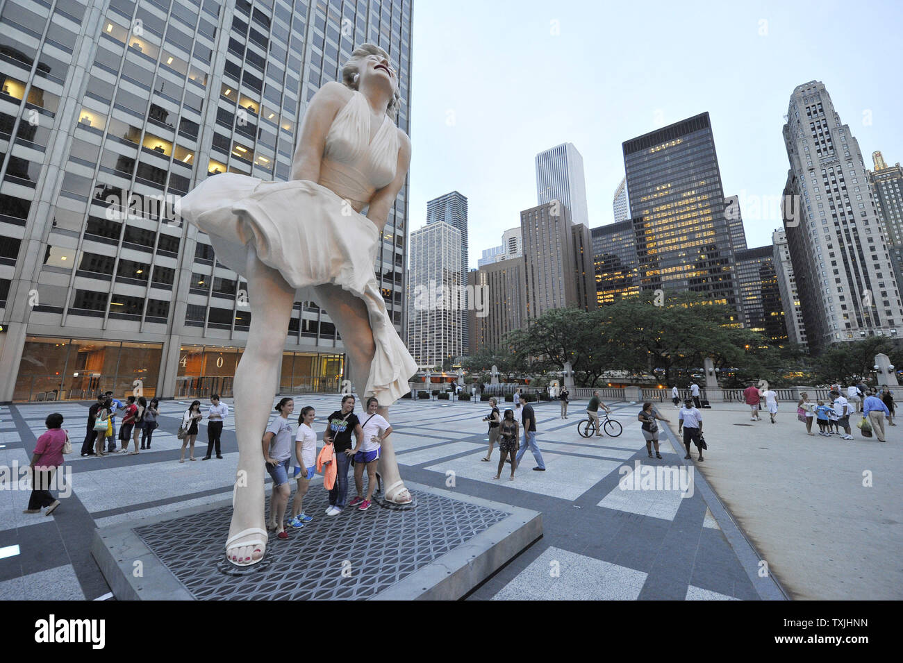 Les gens posent pour des photos avec 'Forever Marilyn', une sculpture de Seward Johnson, le 15 juillet 2011 à Pioneer Plaza à Chicago. Inspirée par Marilyn MonroeÕs posent de l'emblématique 1955 film "sept ans Itch', la sculpture en acier inoxydable et en aluminium est 26 pieds de haut et pèse 34 000 livres et sera à l'affiche au printemps 2012. UPI/Brian Kersey Banque D'Images