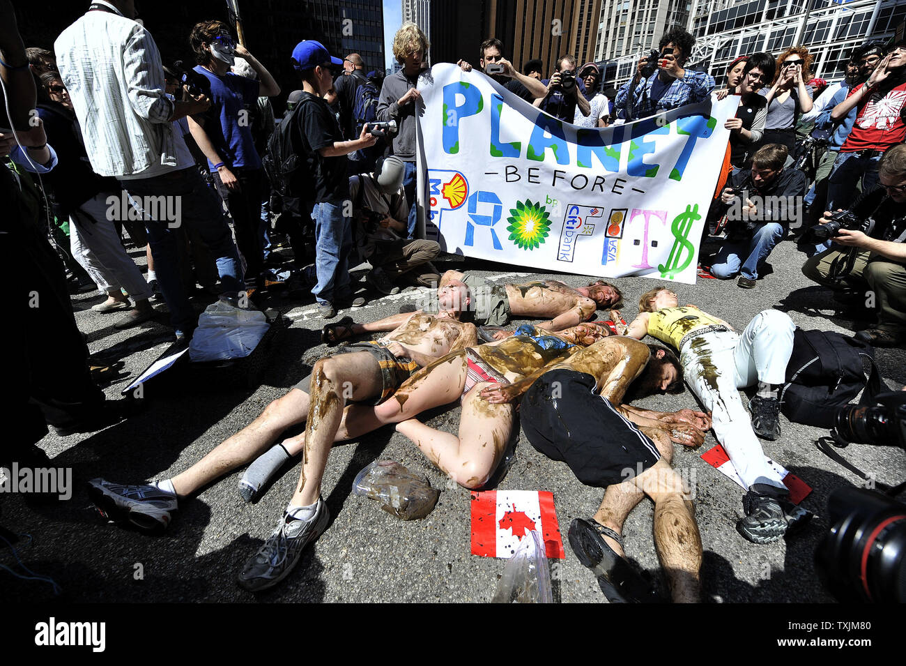 Les protestataires se couvrir en huile simulées et l'étape a' l'extérieur du consulat au cours d'une manifestation contre l'exploitation des sables bitumineux de l'Athabasca et le pipeline Keystone le 17 mai 2012 à Chicago. La protestation a eu lieu dans le cadre de démonstrations d'une semaine avant le sommet de l'OTAN qui aura lieu les 20 et 21 mai à Chicago. UPI/Brian Kersey Banque D'Images