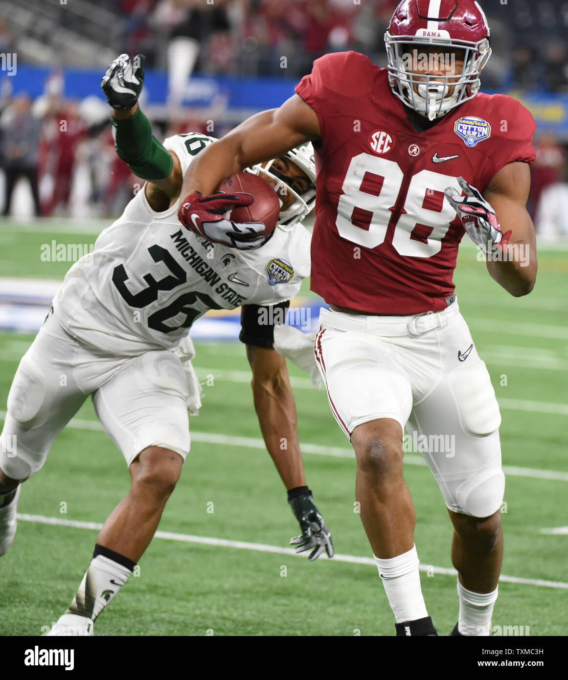 Alabama Crimson Tide's O. J. Howard attrape une passe en face de la Michigan State Spartans Arjen Colquhoun durant la première moitié de la demi-finale des séries éliminatoires de football collégial à la Goodyear Cotton Bowl Classic à AT&T Stadium le 31 décembre 2015 à Arlington, Texas. Photo par Ian Halperin/UPI Banque D'Images