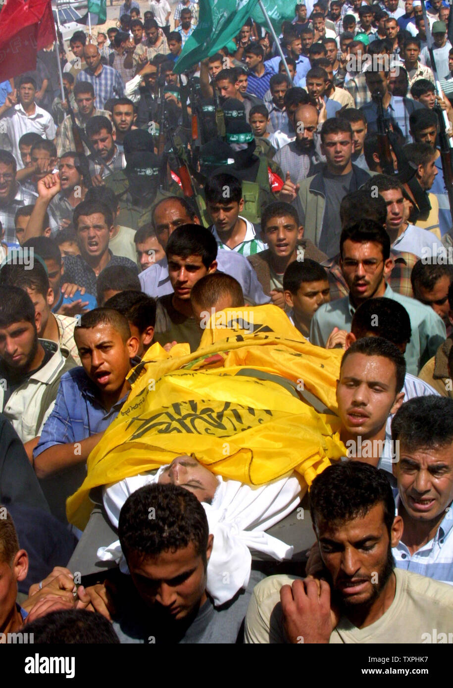 Transporter le corps du défunt palestinien Ahmed de Borika qui a été tué tôt le matin quand il est sorti de sa maison sur la façon d'une mosquée pour les prières, selon des témoins, lors de ses funérailles au camp de réfugiés de Rafah, dans le sud de Gaza, le 20 octobre 2004. (UPI Photo/ Ismael Mohamad) Banque D'Images