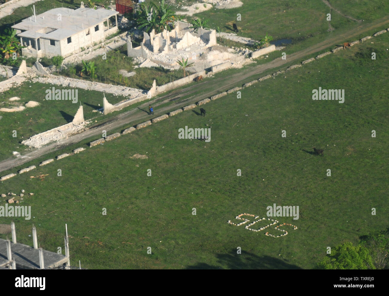 Et SOS sign est écrite sur le terrain à Port-au-Prince, vu depuis un hélicoptère maritime CH-53e pendant une mission d'évaluation, le 18 janvier 2010. L'armée américaine a commencé l'opération United réponse et ne commenceront à donner de l'aide à Haïti après un séisme de magnitude 7,0 qui a frappé le pays. UPI/Kevin Dietsch Banque D'Images