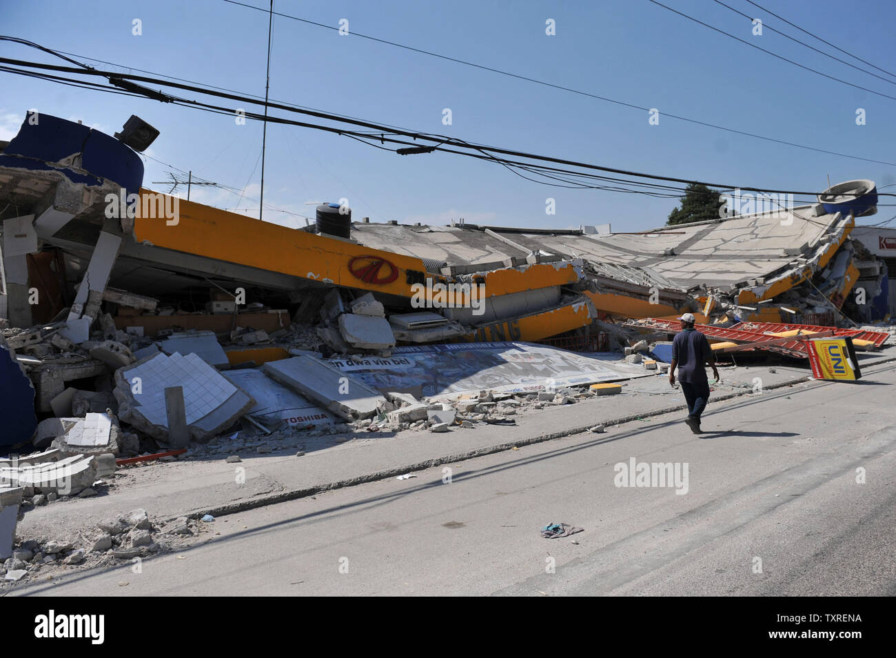 Un homme passe devant un bâtiment endommagé séisme à Port-au-Prince, Haïti le 25 janvier 2010. Haïti continue de souffrir après un séisme de magnitude 7,0 a dévasté le pays le 12 janvier. UPI/Kevin Dietsch Banque D'Images
