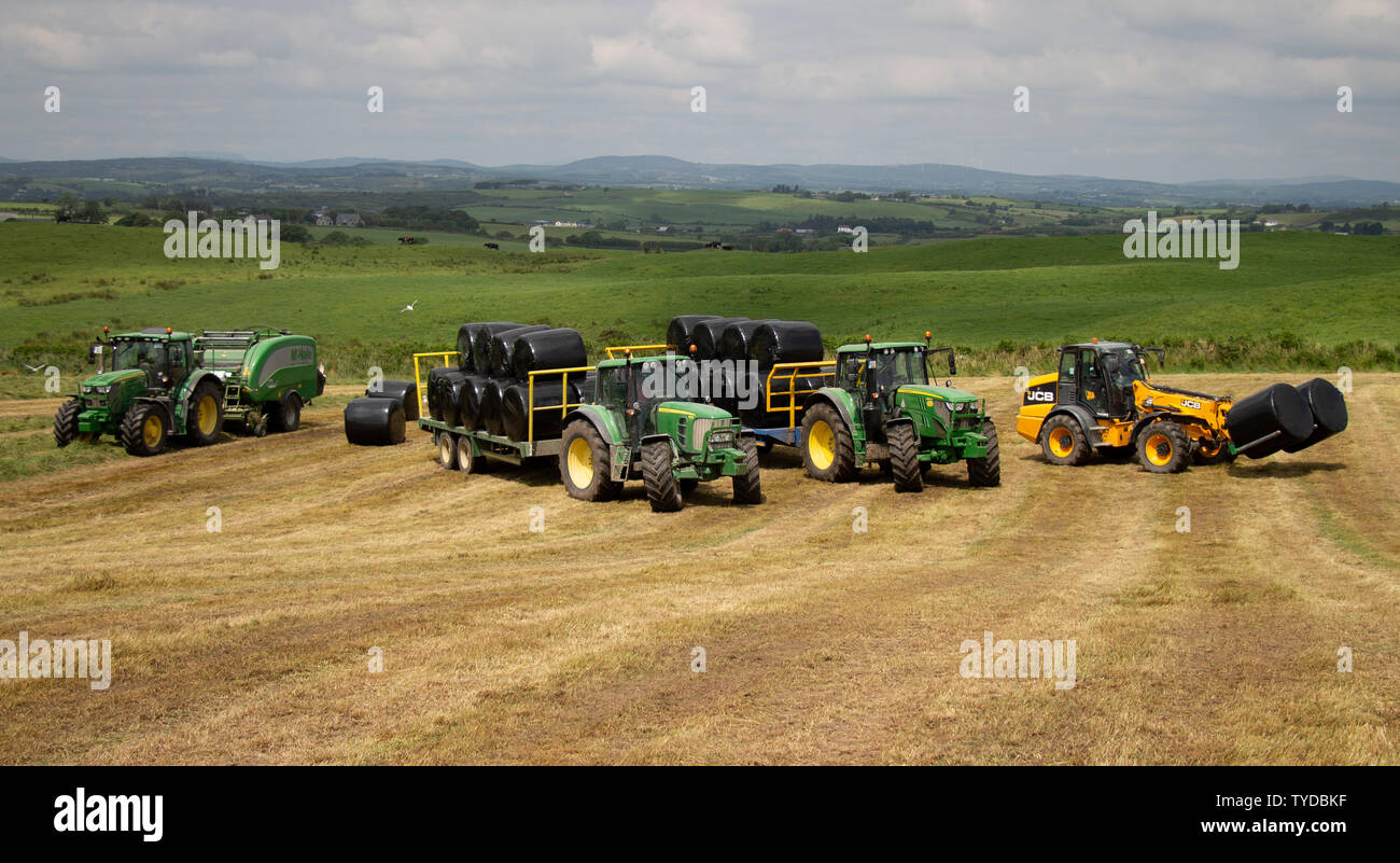 Castlehaven, West Cork, Irlande, 26 juin 2019, une récolte de Castlehaven, récolte Ensilage a besoin de beaucoup de matériel pour les recueillir, les agriculteurs de tirer le meilleur parti du beau temps de les rassembler. Aphperspective crédit/ Alamy Live News Banque D'Images