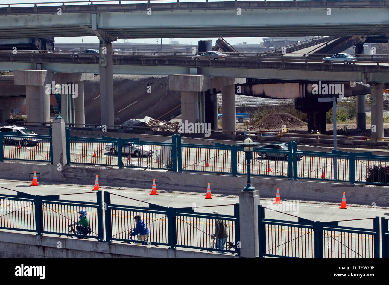 Les cyclistes ride passé une section de l'autoroute s'est effondré près du San Francisco-Oakland Bay Bridge après qu'un camion-citerne d'essence s'est écrasé et a pris feu à Oakland, Californie le 29 avril 2007. (Photo d'UPI/David Yee) Banque D'Images