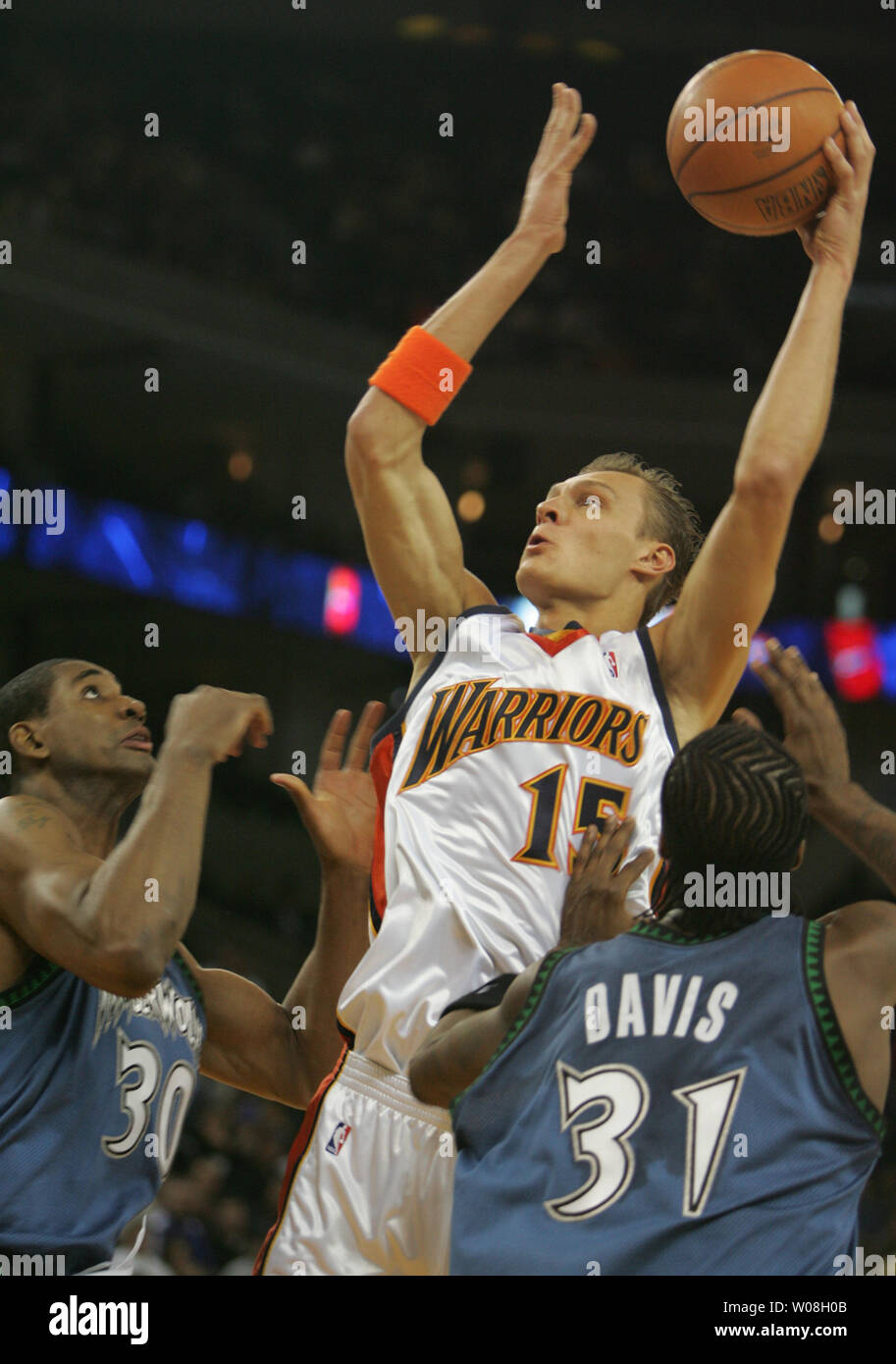 Golden State Warriors Andris Biedrins de Lettonie (15) met en place un shot passé Minnesota Timberwolves Mark Blount (30) et Ricky Davis dans la première moitié de l'action Oracle Arena à Oakland, Californie le 15 avril 2007. (Photo d'UPI/Terry Schmitt) Banque D'Images