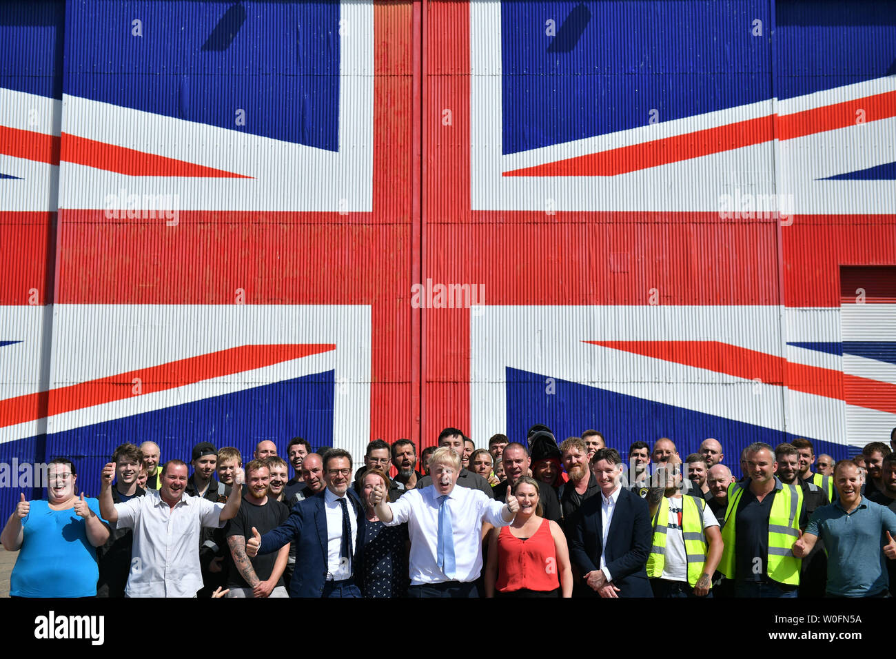 La direction du parti conservateur Boris Johnson contender pose pour une photo avec des mineurs au Wight Shipyard Company à Venture Quay au cours d'une visite à l'île de Wight. Banque D'Images