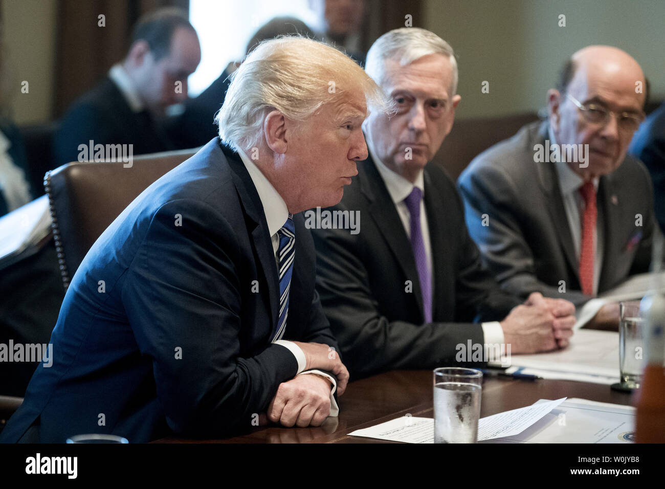 Le président américain, Donald J. Trump parle à côté de la secrétaire de la Défense Jim Mattis (C) et le secrétaire au Commerce Américain Wilbur Ross (R), avec des modèles de fusées vu sur la table, au cours d'une réunion avec les membres de l'atout du Cabinet, dans la salle du Cabinet de la Maison Blanche à Washington, D.C. le 8 mars 2018. Photo de Michael Reynolds/UPI Banque D'Images