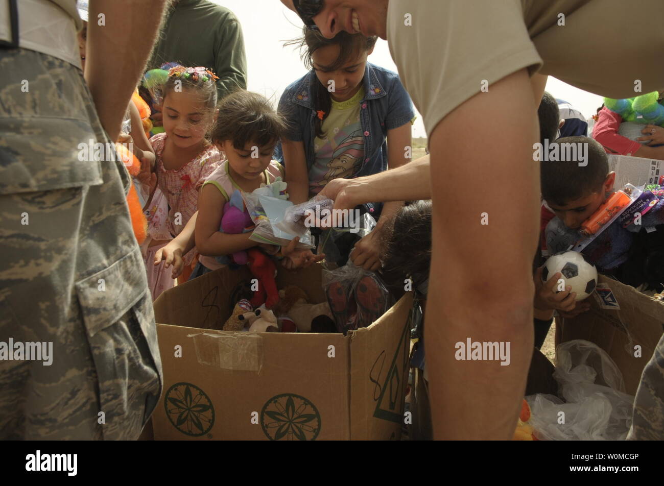 Les membres de l'US Air Force de main jouets et cadeaux pour les enfants irakiens à Sather Air Base, l'Iraq, le 6 juin 2008. Les aviateurs ont visité avec les enfants à faire don de jouets et cadeaux qui venaient de la Good Neighbor programme parrainé par le groupe expéditionnaire de la 447e. (Photo d'UPI/Tech. Le Sgt. Jeffrey Allen/USAF) Banque D'Images