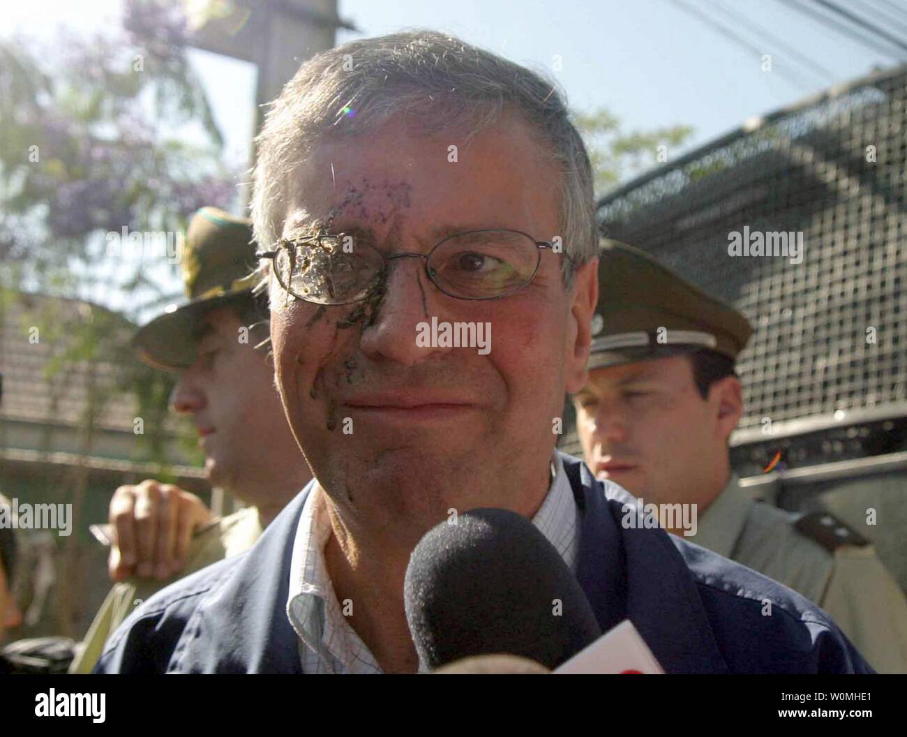 Metropolitan maire Fernando Echeverria est frappé dans l'oeil par un objet après avoir essayé de dire à des parents et amis des prisonniers à propos de la situation à la prison de San Miguel après un incendie s'est propagé par le développement de la mort de plus de 80 au sud de Santiago du Chili le 8 décembre 2010. Un feu a été mis au cours d'une émeute dans la prison qui détient 1 900 mais a été construit pour 700. UPI/Sebastian Padilla Banque D'Images