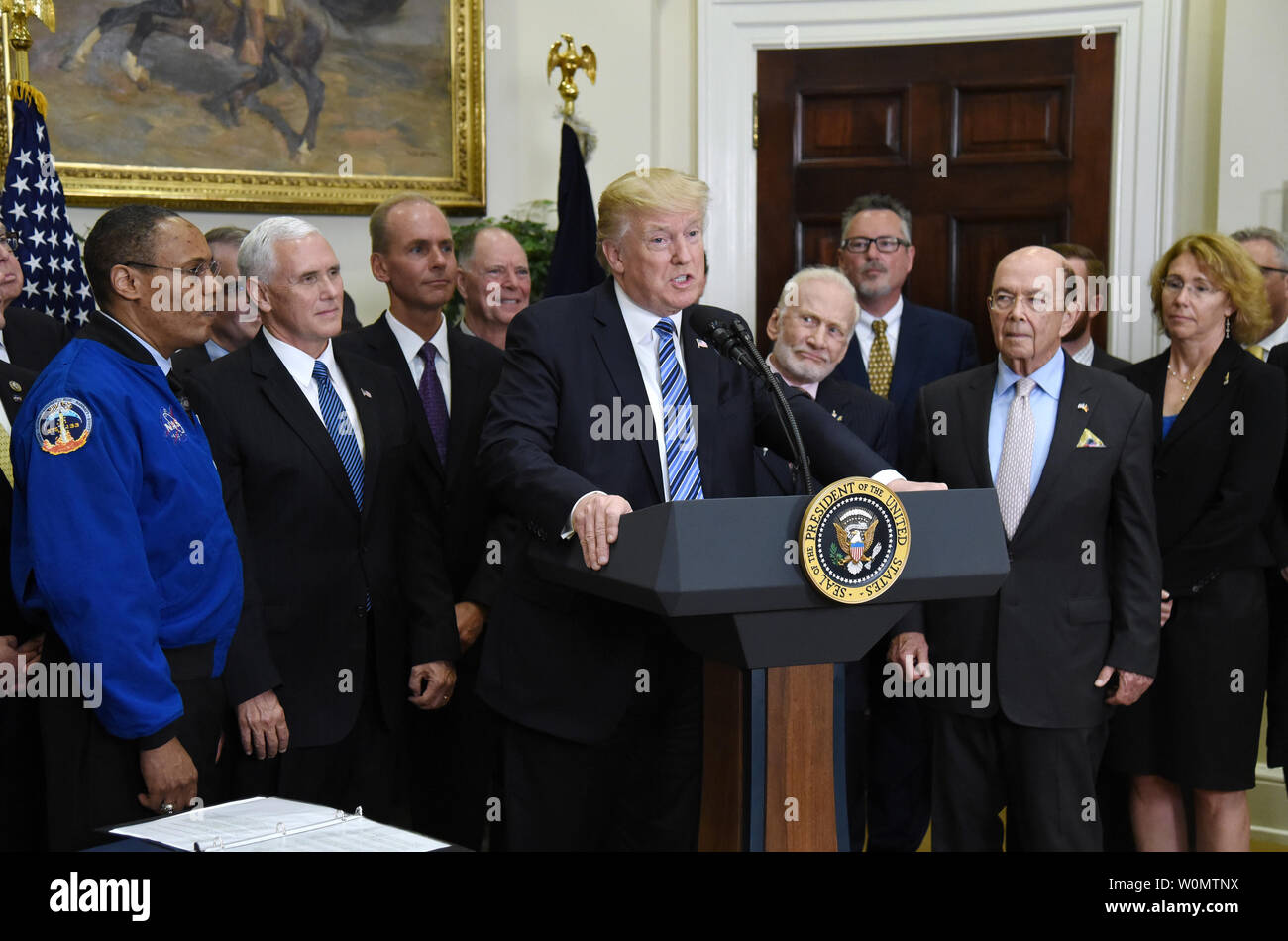 Président américain Donald Trump flanqué par le vice-président Mike pence (2-L), Apollo 11 Buzz Aldrin astronaute (5-L) et ministre du Commerce, Wilbur Ross (R) parle avant de signer un décret pour rétablir le Conseil national de l'espace dans la Roosevelt Room de la Maison Blanche à Washington, DC, le 30 juin 2017. Photo par Olivier Douliery/UPI Banque D'Images