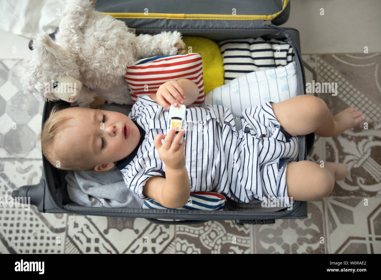 Bébé jouant avec des jouets dans suitcase Banque D'Images