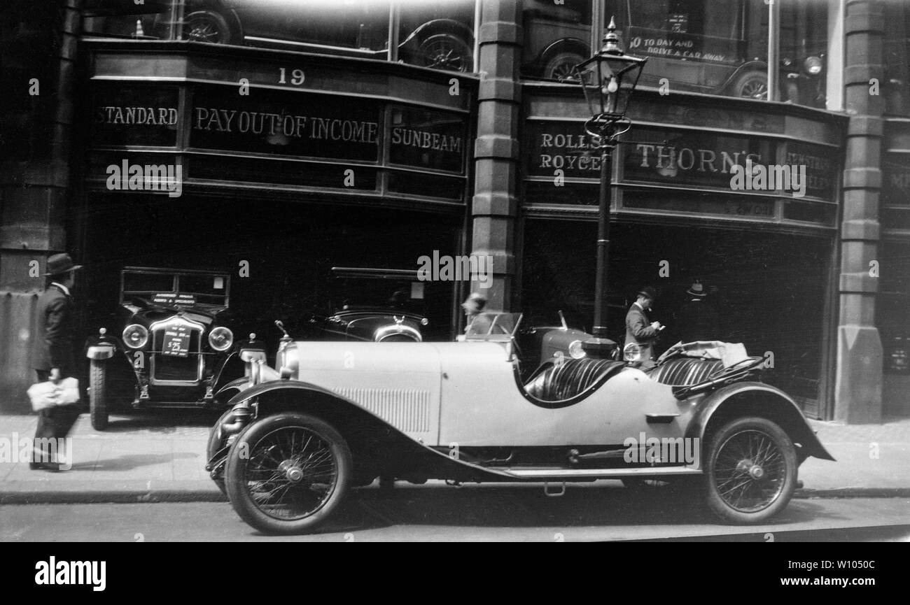 Vintage photo d'une voiture garée sur une route dans une ville. Banque D'Images