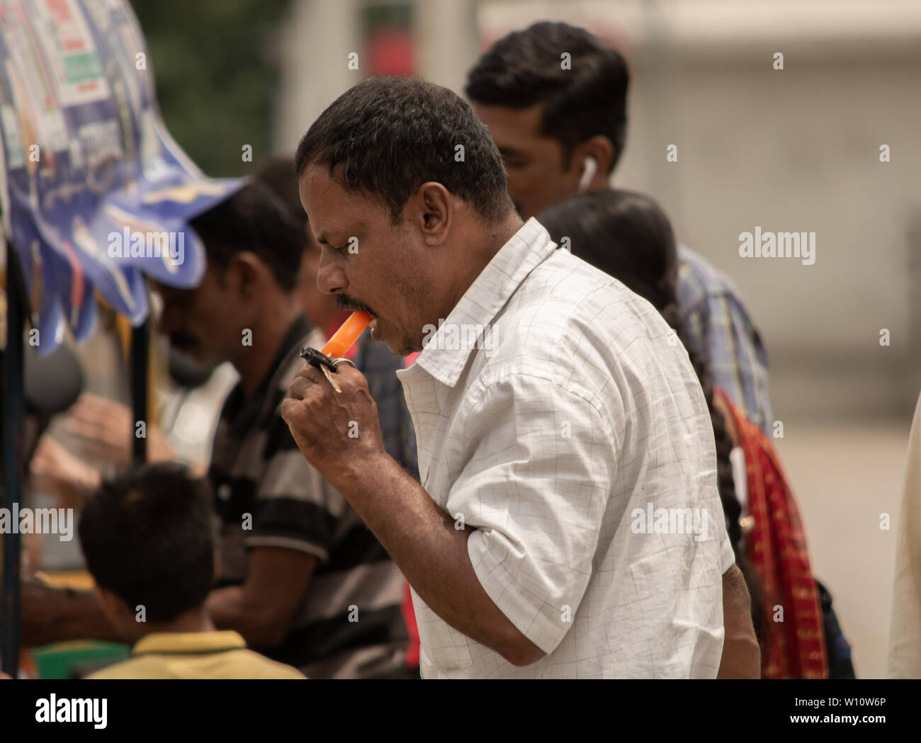 Bangalore, Karnataka, India-June 04 2019 : Man eating ice cream on jour ensoleillé chaud près de Vidhana Soudha à Bengaluru. Banque D'Images