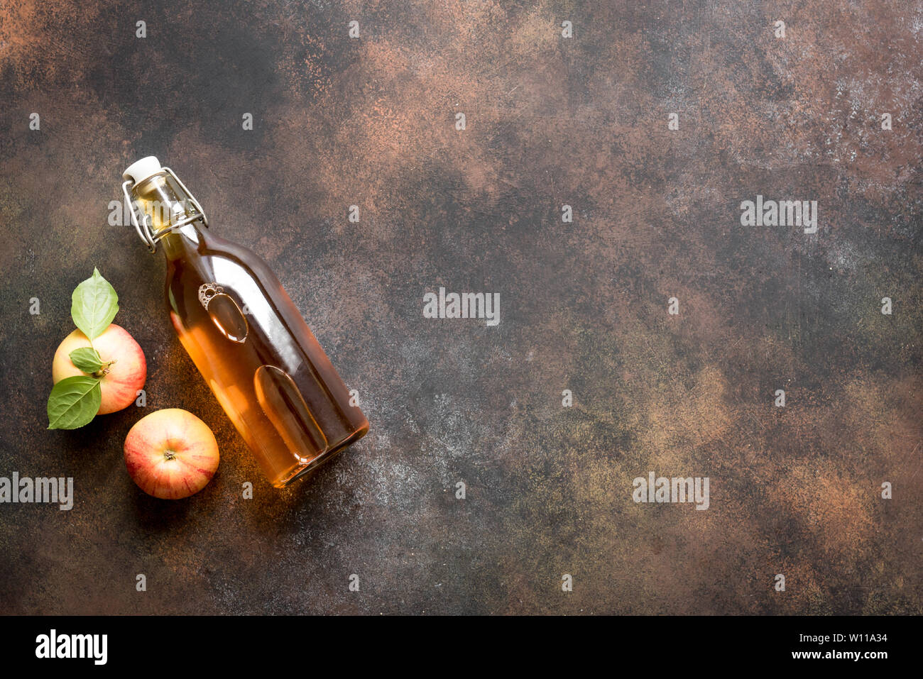 Le vinaigre de cidre de pomme ou de fruits pour boissons fermentées et les pommes biologiques sur sombre, vue du dessus, copiez l'espace. La saine alimentation et le style de concept. Banque D'Images