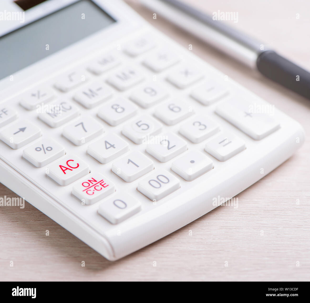 Calculatrice et stylo blanc sur la table en bois clair, analytique et statistique de profit financier, le risque d'investissement concept, copy space, macro, Close up Banque D'Images
