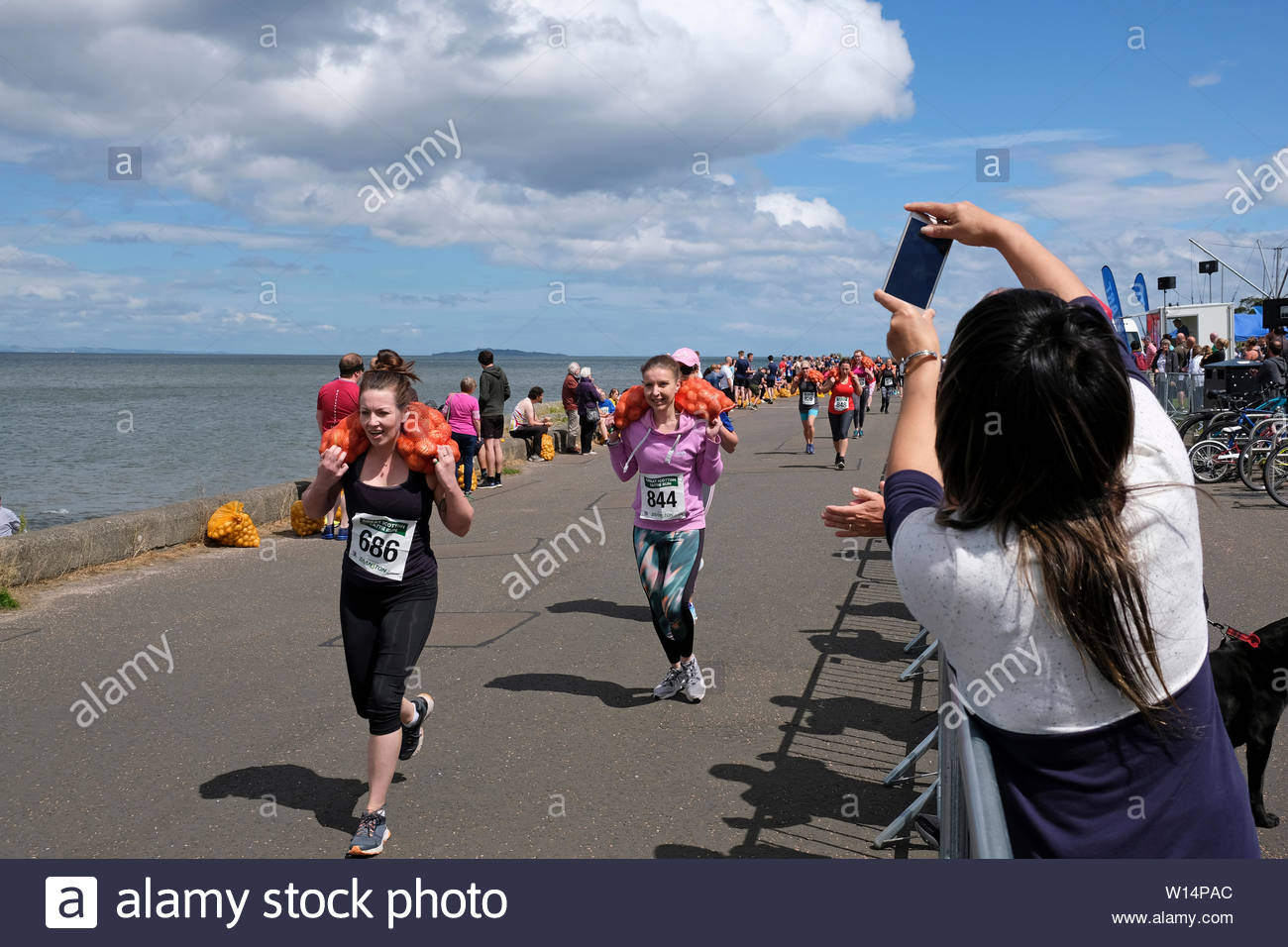 Edinburgh, Ecosse, Royaume-Uni. 30 juin 2019. Le Grand Scottish Tattie fonctionner à Silverknowes Promenade, organisée par de grands événements écossais, un événement de collecte de fonds du groupe organisateur. La course est d'un mille avec un sac de pommes de 20 kilo pour les hommes,10 kilos pour les femmes. Tous les participants obtiennent de garder leur sac de tatties. Credit:Craig Brown Banque D'Images