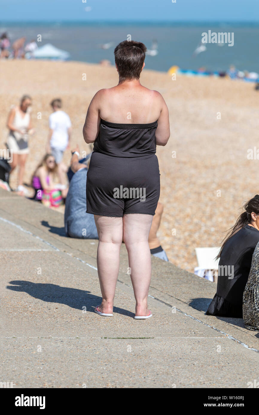 Un excès de woman looking at a beach Banque D'Images