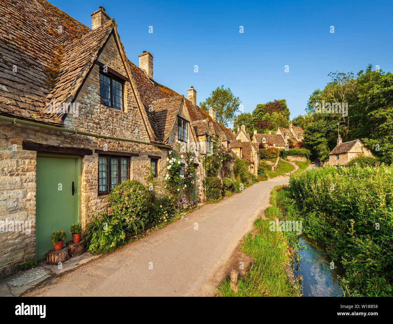 Rangée de 600 ans English Cotswolds chalets en pierre. Arlington Row, Bibury, Gloucestershire, Angleterre, Royaume-Uni. Banque D'Images