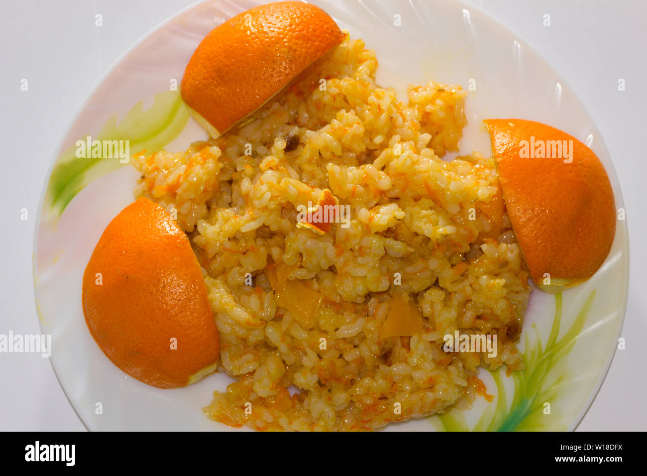Pilaf maigre avec des poivrons et barberries sur une assiette décorée avec des oranges Banque D'Images