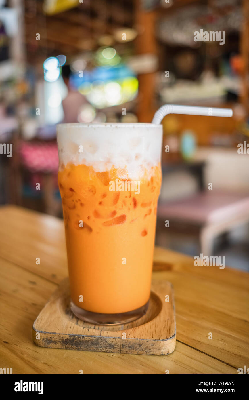 Thé glacé thaï avec de la crème sur la table à café en plein air Banque D'Images