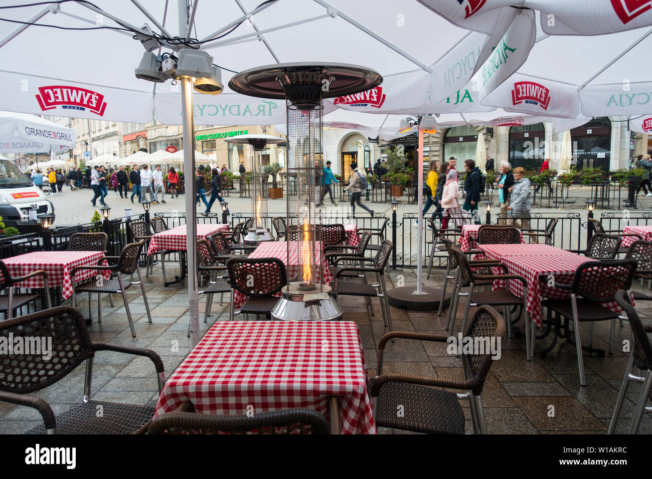 Restaurant extérieur Lampes de chauffage allumé lors d'une fraîche soirée d'été, Cracovie, Pologne, Europe. Banque D'Images