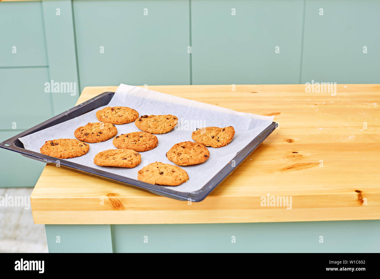 Cookies aux pépites de chocolat sur une plaque sur une table en bois. Un espace réservé au texte Banque D'Images
