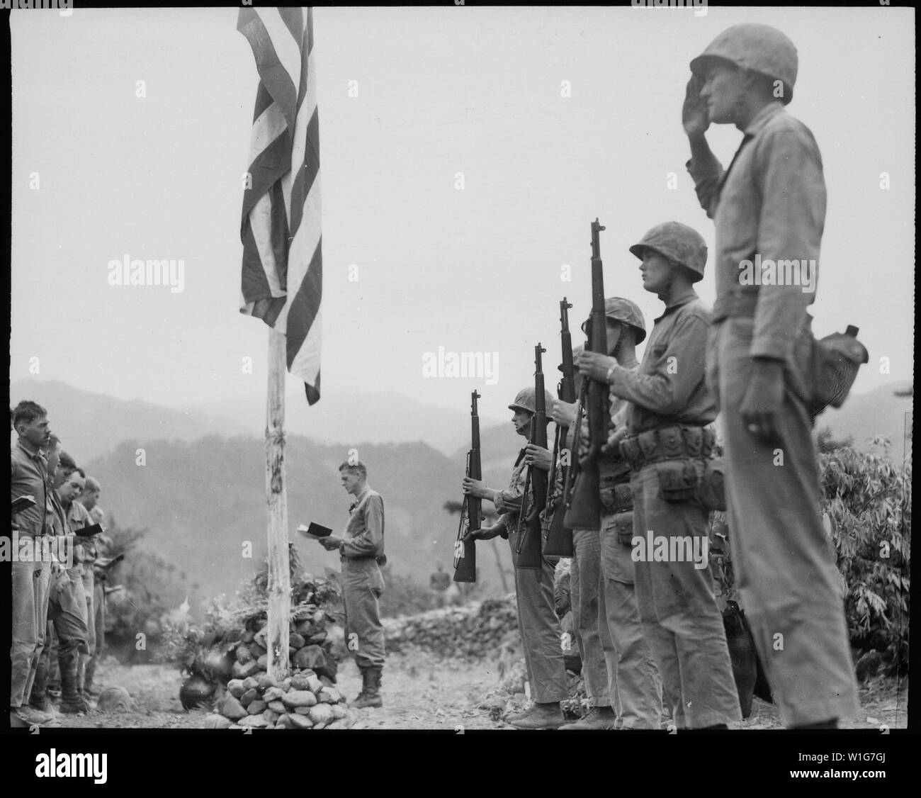 Le Lieutenant-colonel John Hopkins, commandant du Premier bataillon, 5e Régiment de Marines, conduit dans le chant de l'hymne national lors des services commémoratifs tenus sur le terrain pendant la campagne de Corée. ; notes générales : utilisation de la guerre et des conflits Nombre 1401 lors de la commande d'une reproduction ou demande d'informations sur cette image. Banque D'Images