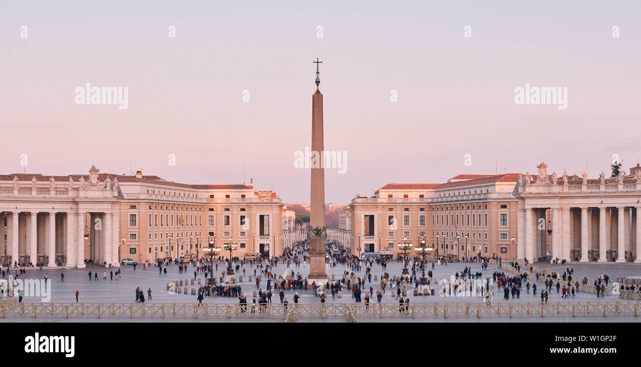 Rome, Italie, 20 février 2019, la Place Saint Pierre au coucher du soleil, vue de la Basilique Saint Pierre. Les touristes à pied sur la place. Banque D'Images