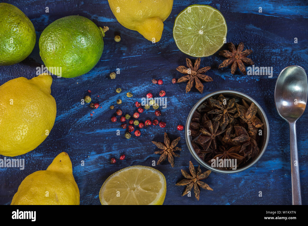 Ingrédients Cocktail citron,rose,et le poivron vert et l'étoile d'anis sur fond bleu Banque D'Images