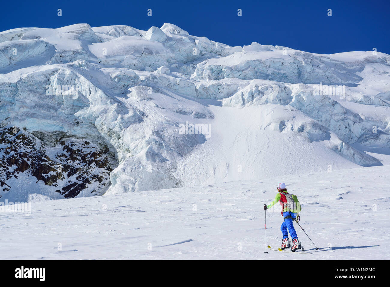 Femme ski ordre croissant vers cascade, Punta San Matteo, Val dei Forni, gamme Ortler, Lombardie, Italie Banque D'Images