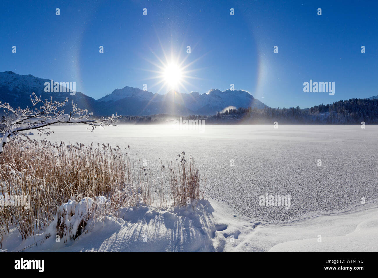 Halo (effet arc-en-ciel produit par frost mist en l'air), paysage d'hiver à Barmsee, vue de Soiern et gamme gamme Karwendel, Bavière, Allemagne Banque D'Images