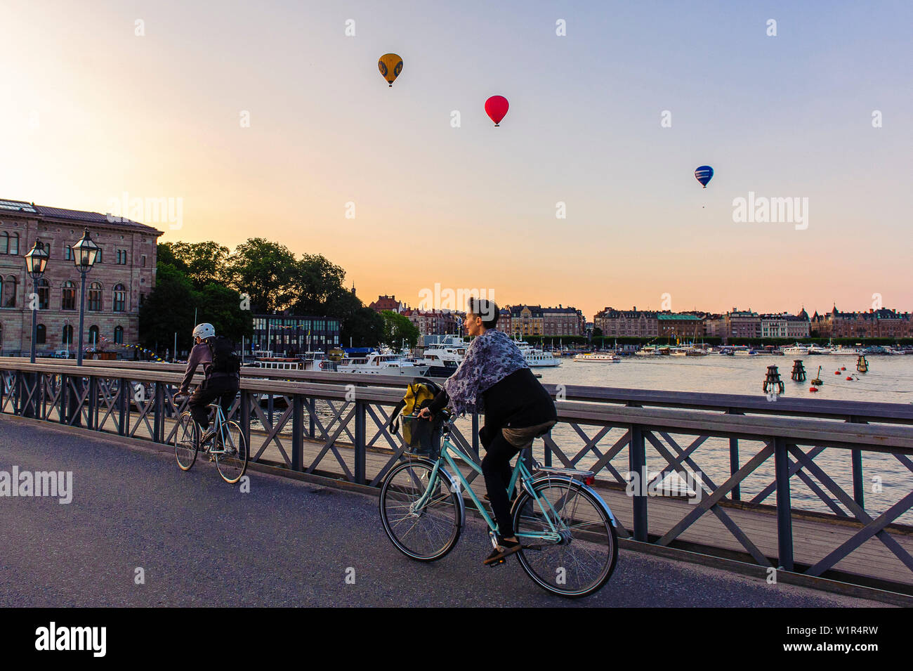 Sur le Skeppsholmsbron cycliste. Ballons à air chaud à l'arrière-plan, Stockholm, Suède Banque D'Images
