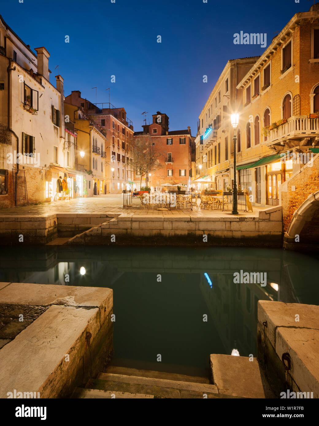 Maisons illuminées dans Campo Santa Maria Nova et canal Rio del Miracoli en bleu crépuscule, Cannaregio, Venise, Vénétie, Italie Banque D'Images