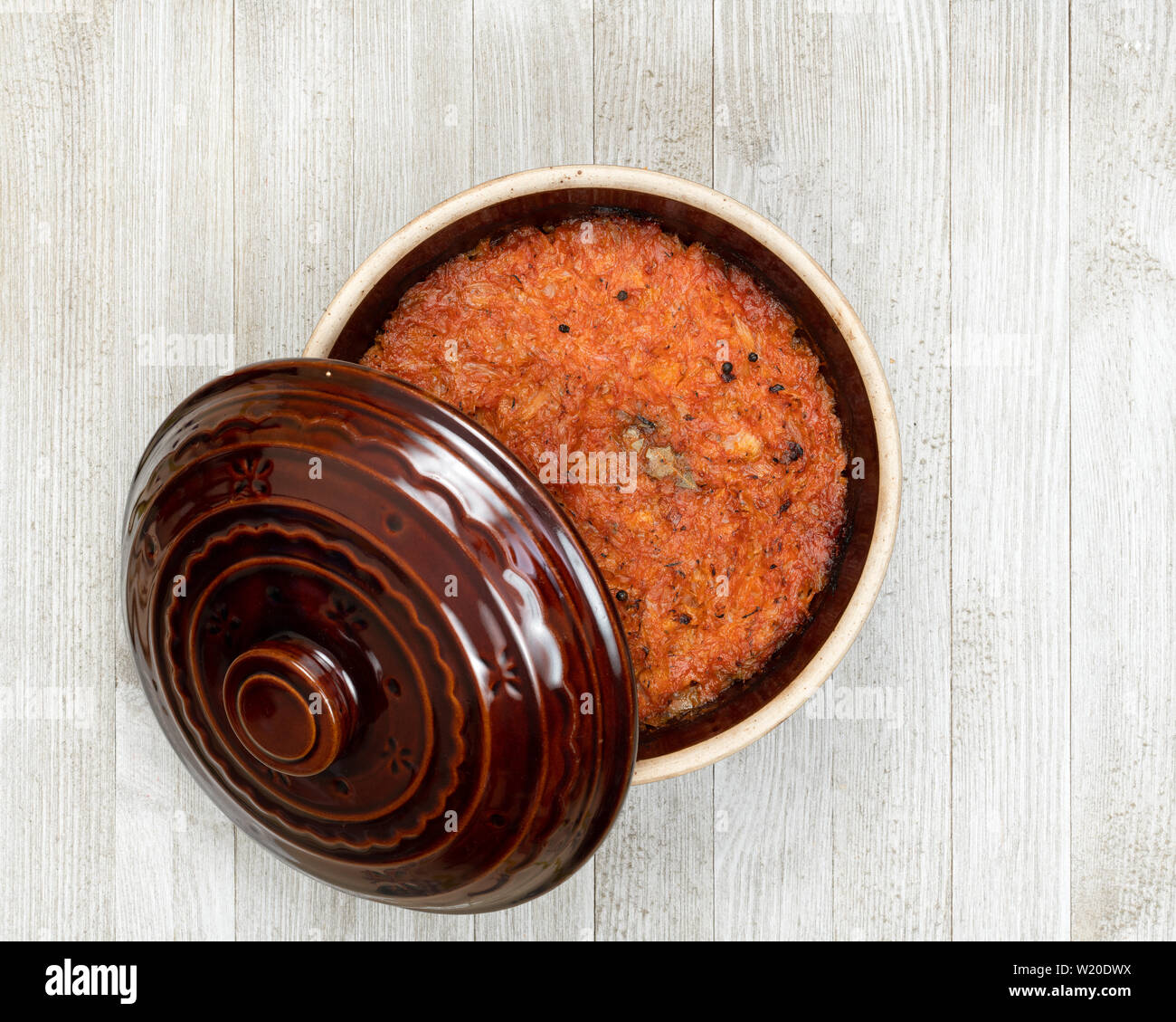 Un pot en céramique d'Europe orientale traditionnelle compote de chou sur une cuisine en bois blanc. Banque D'Images