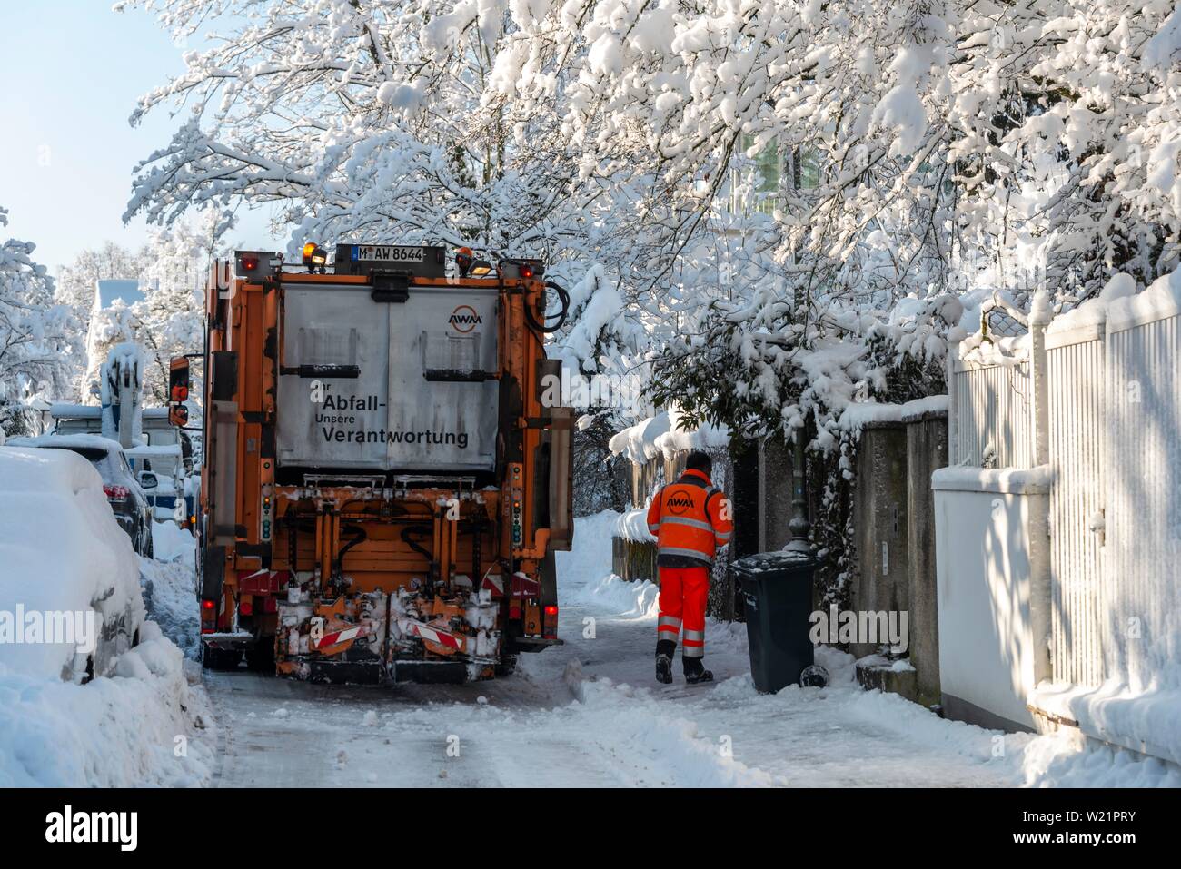 Collecte des ordures dans la neige dans des rues étroites avec des wagons couverts de neige, Munich, Haute-Bavière, Bavière, Allemagne Banque D'Images