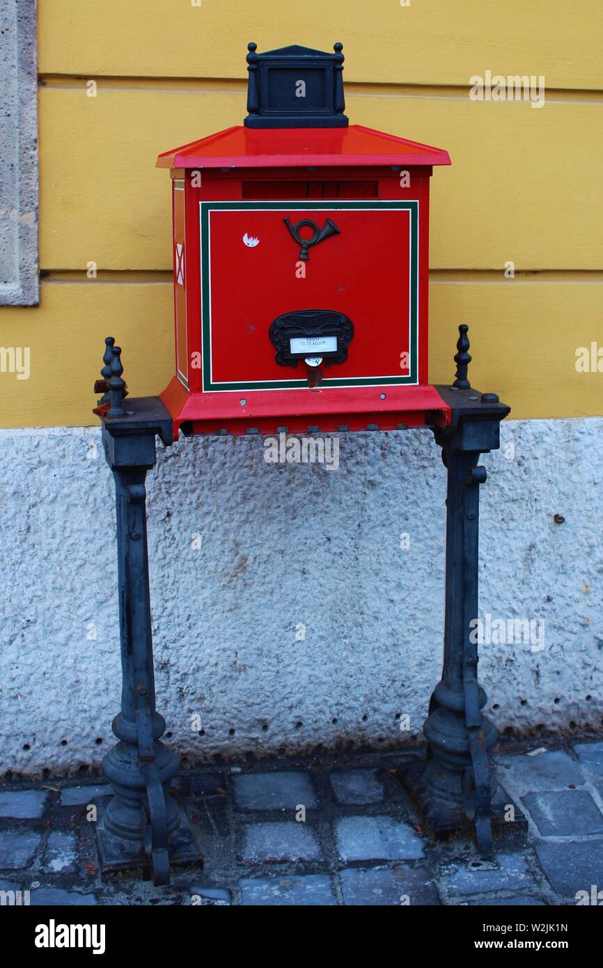 Un traditionnel, rouge, autoportant, boite aux lettres, dans la rue devant le "posta" (bureau de poste), dans la colline du Château de Buda, district de Budapest, Hongrie. Banque D'Images