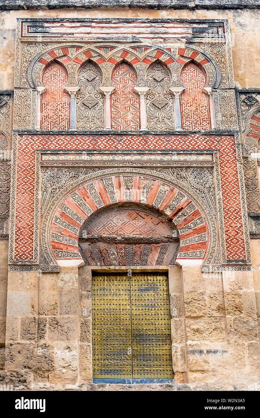 La Mosquée Cathédrale de Cordoue, Espagne. Mur extérieur avec une grande porte d'or - célèbre en Andalousie Banque D'Images