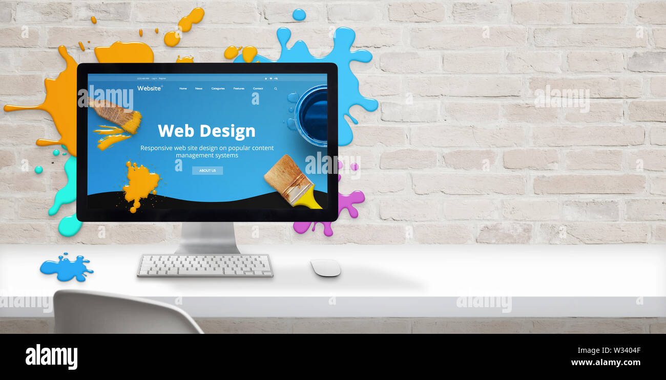 Web design studio concept avec site web moderne et design web teme texte sur l'écran de l'ordinateur entouré de gouttes de couleur. À côté de l'espace libre sur mur de brique Banque D'Images