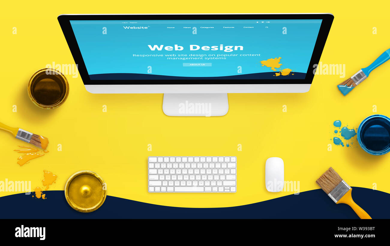 Creative web design studio 24 jaune avec des pinceaux et couleurs des boîtes et mise en page thème web peint sur l'écran d'un ordinateur. Banque D'Images